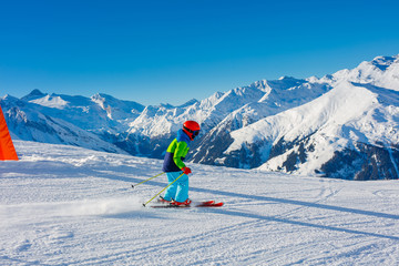 Cute skier boy in a winter ski resort.