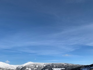 peaks of Krkonose mountains with forest covered in snow