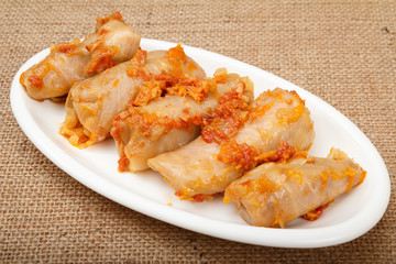 Delicious homemade cabbage rolls stuffed with rice and meat on dish.