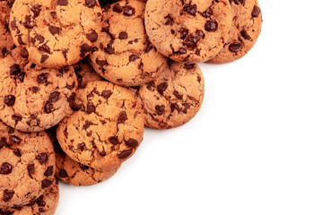 Many freshly baked chocolate chip cookies, shot from above on white, an abstract sweet biscuits background with a place for text