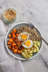 Quinoa salad in bowl with avocado