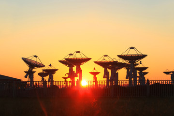 The silhouette of a radio telescope