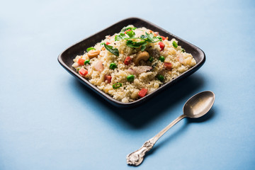 Rava Upma / Uppuma - south indian breakfast served in a bowl. selective focus