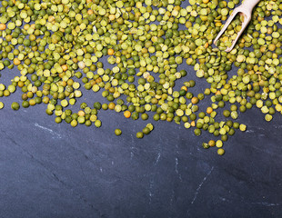 Dried green peas legumes one slate background, top view