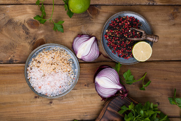 Fresh parsley and red peppercorns, sea salt and spices. Blue onions and lime. Ingredients for avocado sauce with. Top view.