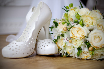 Wedding shoes and wedding paraphernalia, wedding bouquet, wedding gold rings. 
