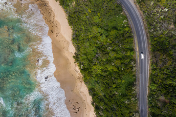 Overhead view of the great ocean road among the forest and next to the coastline in Victoria, Australia