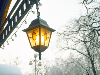 Fototapeta na wymiar Streetlights shine, a winter urban view. 