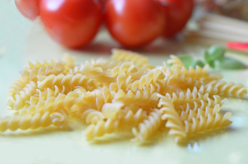 composition of healthy food ingredients on white background, top view. Ingredients for making macron, spaghetti, pasta. Tomatoes, basil, parmesan cheese, grater