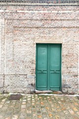 old wooden door in brick wall