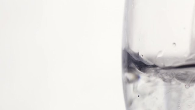 Soda water in a glass on a white background large plan. close-up.