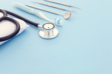 Dental care tools use for dentist in the clinic. Wooden blue background.