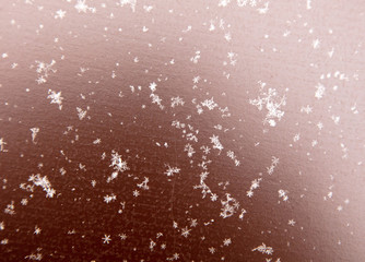 Snowflakes on a brown metallic background