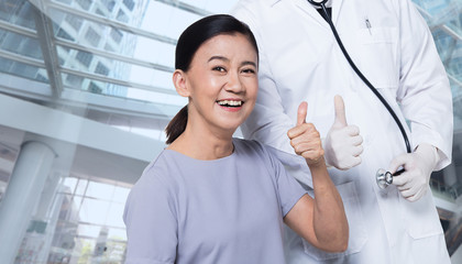 Asian Middle 60s age Woman Patient check up health with Doctor.  Aging Society lady concern on healthcare diagnose good thumb up with medical expertise, studio lighting isolated copy space text logo