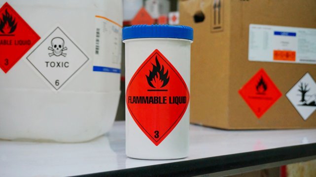Variety type of chemical container with  many of chemical hazard warning symbols. Flammable warning symbol, Toxic warning symbol, Hazardous to the Environment symbol.