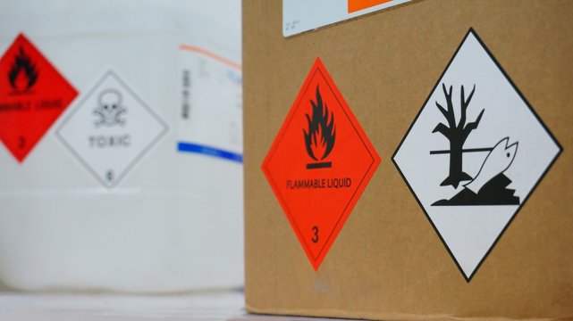 Variety type of chemical container with  many of chemical hazard warning symbols. Flammable warning symbol, Toxic warning symbol, Hazardous to the Environment symbol.
