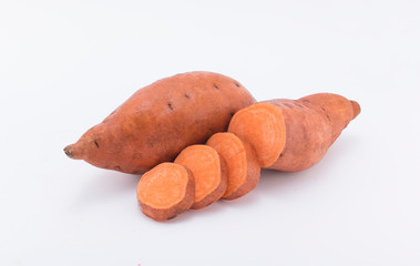 Raw sweet potatoes on wooden background closeup white background