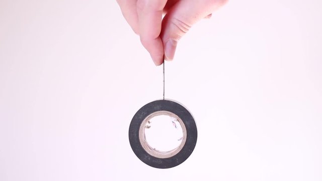 Hanging insulating tape in male hand