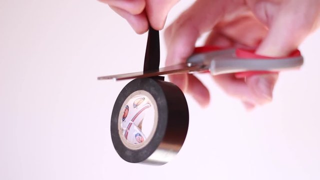 Cutting insulating tape with scissors