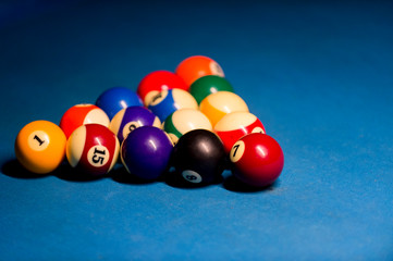 Billiard balls on pool blue table - sport background