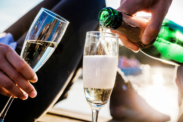 Man and woman drinking champagne outside. Horizontal photo