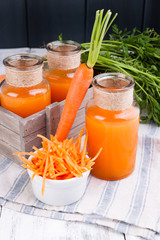 fresh carrot juice in a jar. Fresh carrots with leaves and drink. Spring food for health and beauty. Free space for text.
