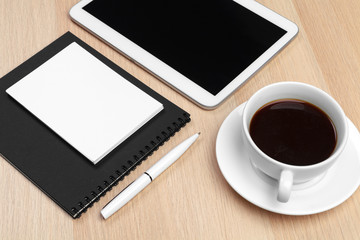 Obraz na płótnie Canvas Digital tablet with notepad, supplies and coffee cup on desktop.