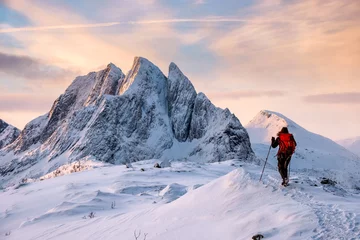 Fotobehang Mountaineer man climbs on top snowy mountain © Mumemories