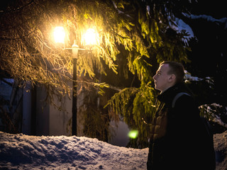 attractive man walk in city beetwen nightlights. winter season b