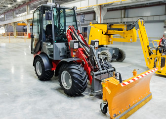 yellow bulldozer at the factory in room © Elena