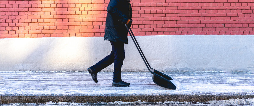 Adult Man Shoveling Snow From City Streets