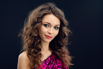 Portrait of a smilling  girl posing against a black wall background  - Image