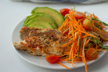 Grilled chicken and vegetable salad closeup.