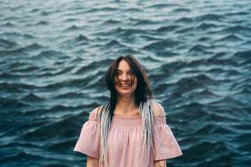 portrait of a girl in heart glasses in front of wall of sea 