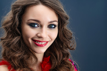 Portrait of enthusiastic beautiful  woman over blue background сloseup- Image