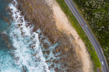 Overhead view of the great ocean road among the forest and next to the coastline in Victoria, Australia