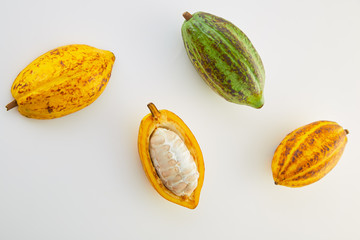 Fresh cocoa fruits with green leaf on white background