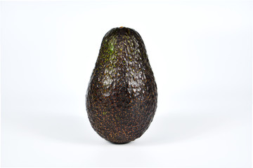 Whole avocado isolated on white background.