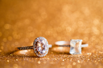 Jewelry diamond ring with abstract festive glitter Christmas holiday texture background blur with bokeh light