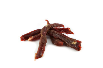 Long sliced of dried meat beef jerky dry isolated on white background
