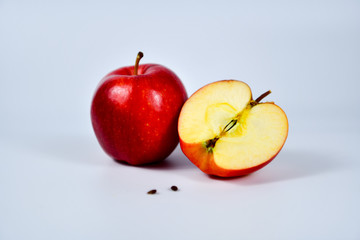 Red apple and slice on a white background.