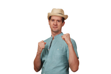 The man in a shirt and a hat keeps hands in a boxing rack