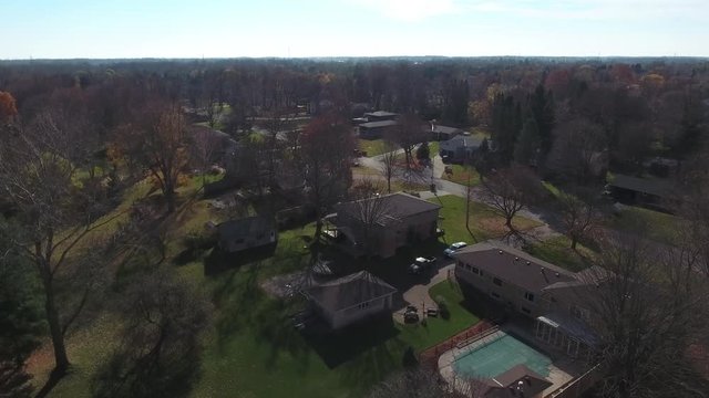 Flying Over A House By Park With Trees