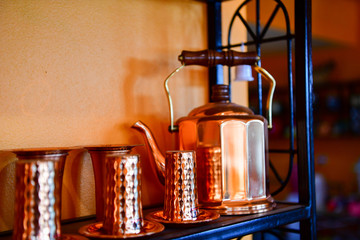 Cup and jug made of copper for water, tea, coffee or wine.