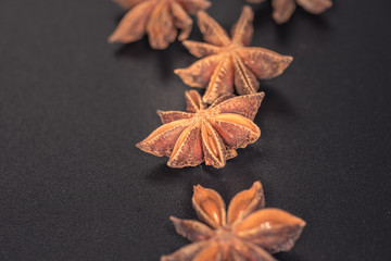 Asian spices, Star anise spice fruits and seeds isolated on black background closeup