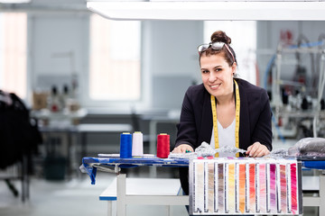 Woman designer posing in factory.