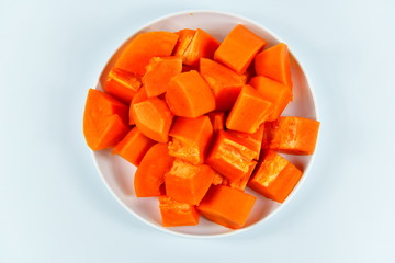 Slices of papaya on white background.