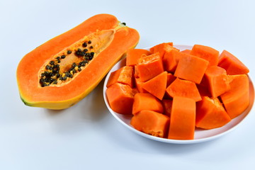 Slices of papaya on white background.