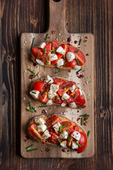 Italian bruschetta: bread with tomatoes, mozzarella and spices