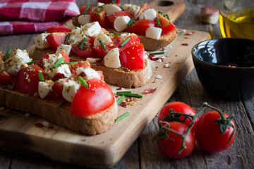 Italian bruschetta: bread with tomatoes, mozzarella and spices